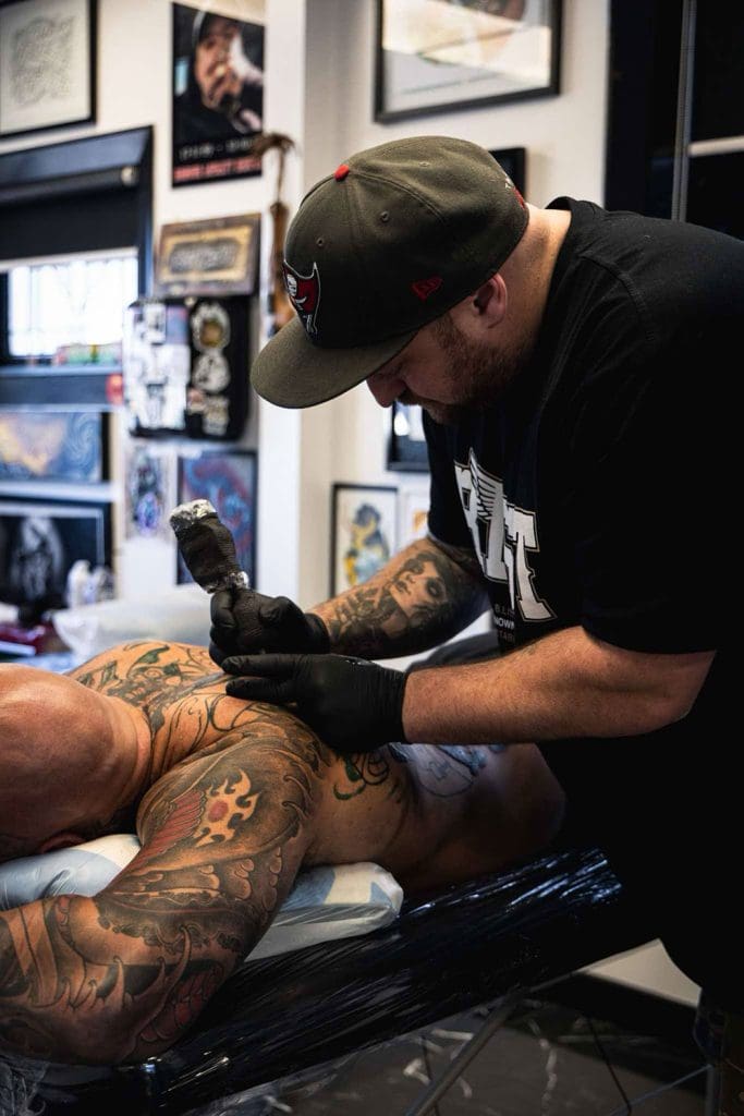 Ekos tattooing a client at B.List Tattoo Studio in Christchurch